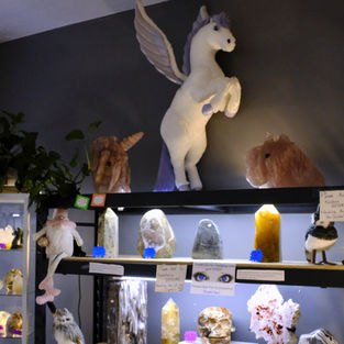 very large crystals and a unicorn on top of the shelf