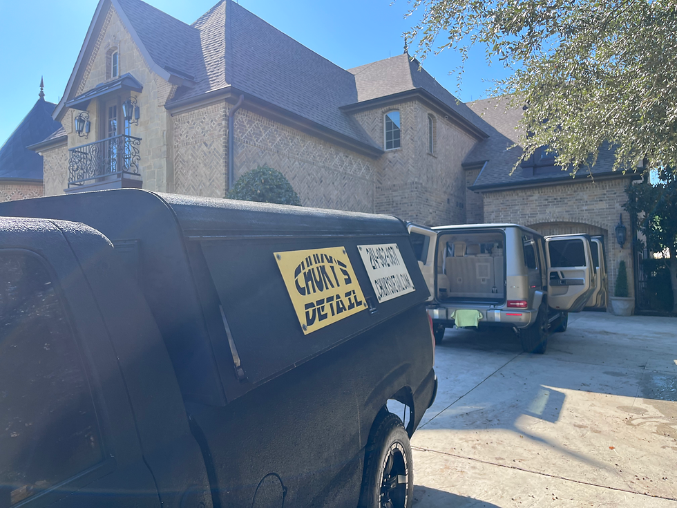 Eye-level view of a mobile detailing van parked in a residential driveway