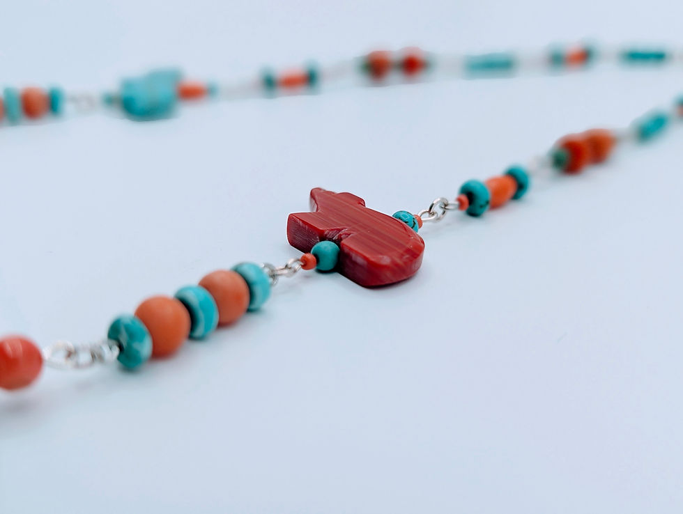 Thumbnail: A white goat bone necklace wrapped in turquoise and coral beadwork, featuring carved turquoise animals and a silver toggle cl