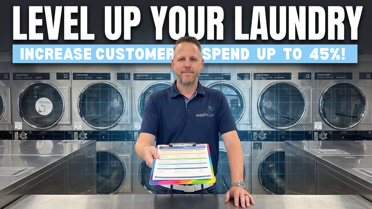 Josh Chapman holding the Level Up Your Laundry clipboard card inside a Wash Bar laundromat