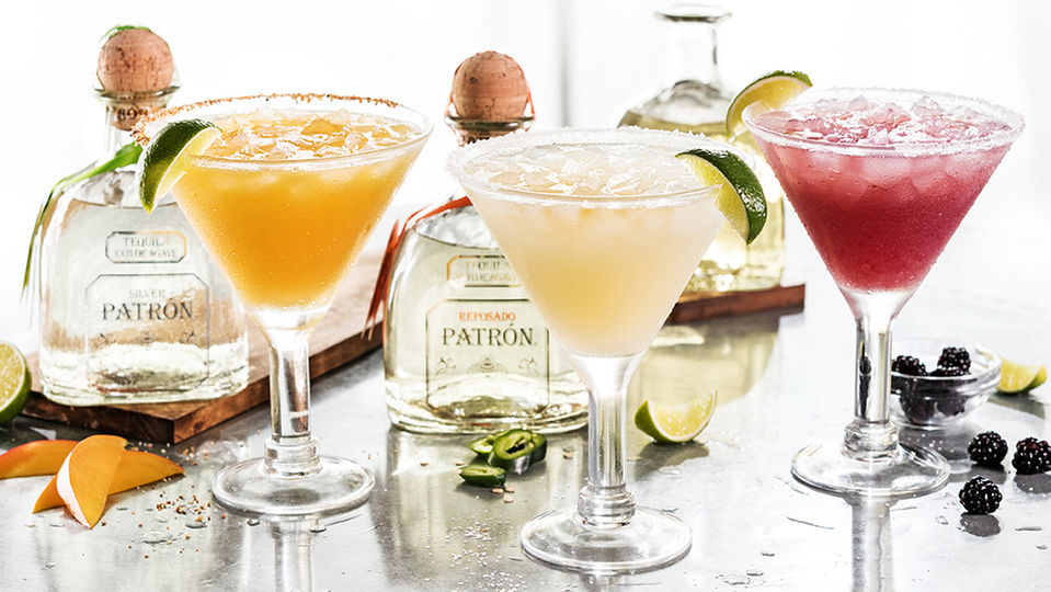 Three flavored margaritas on bar top with bottles, Dallas Beverage photography