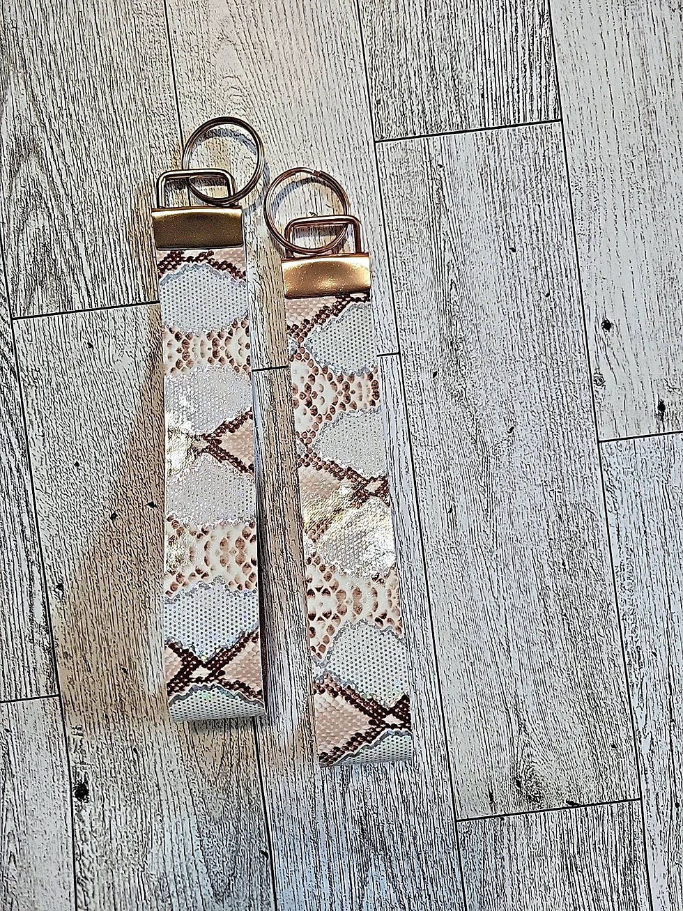 Thumbnail: Faux leather key fobs with metal hardware.