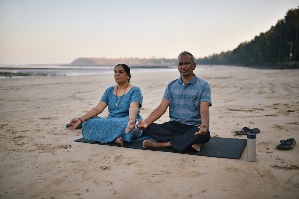A couple meditating on a beach