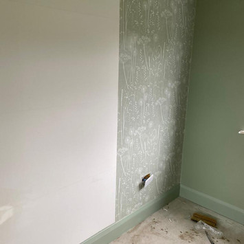 delicate floral wallpaper being installed