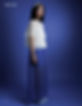Woman in white ruffled top and blue skirt for MOEVIR