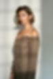Woman in an off-the-shoulder brown dress.