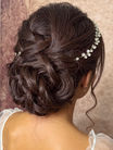 Elegant updo hairstyle with intricate curls, WEDDING HAIR AND MAKEUP, beautiful bridal look.