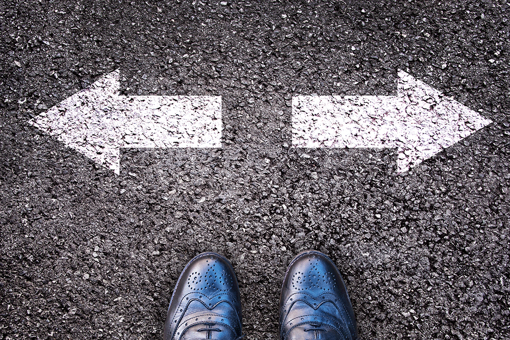 Set of feet in front of two opposing direction arrows