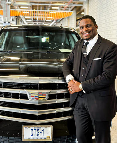 Deluxe Transportation Group man standing infront of a car 