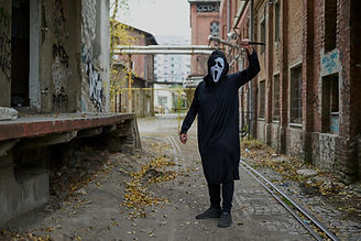 "Dilapidated film set with broken props and empty facades, capturing the eerie silence of abandoned Hollywood-style haunted locations in the West"