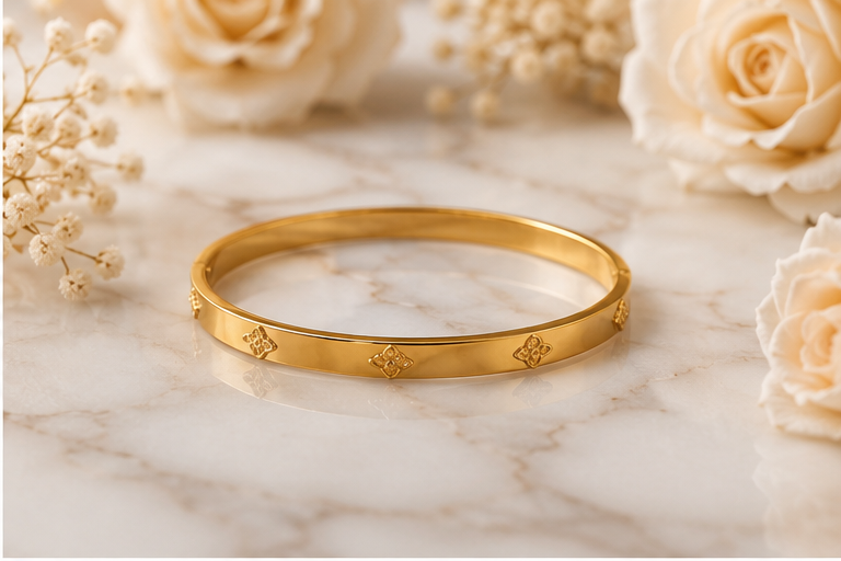 Thumbnail: 18K Gold Plated Clover Motif Bangle sitting on white marble