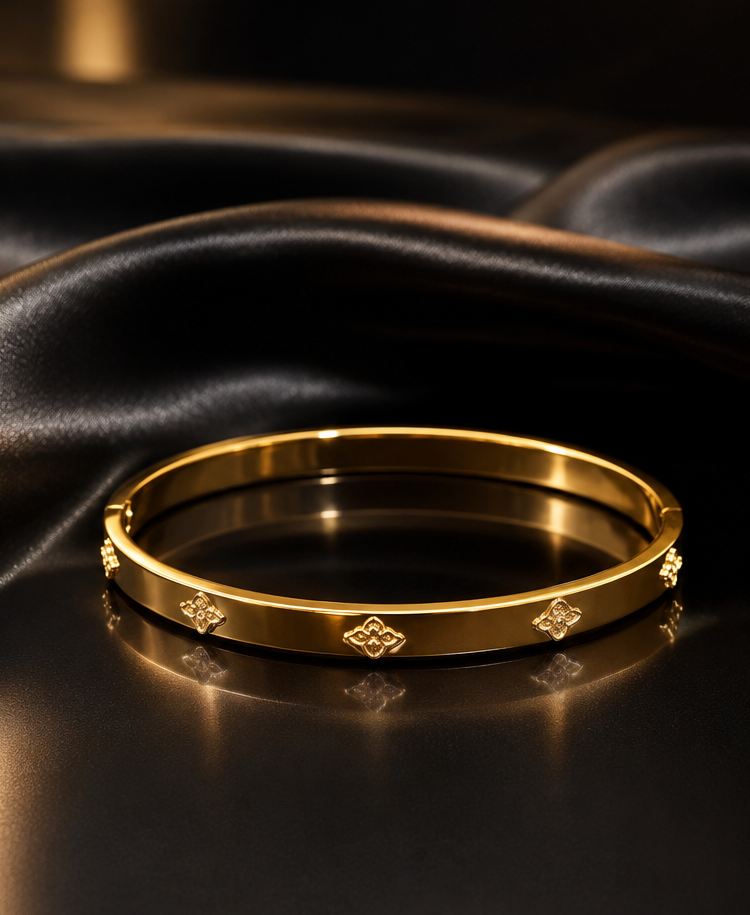 18K Gold Plated Clover Motif Bangle on shiny black satin