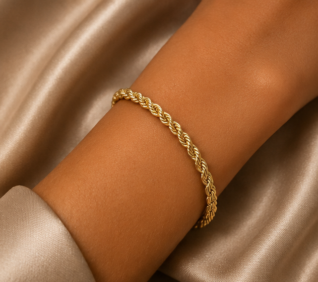 Thumbnail: 18K Gold Plated Rope Bracelet on a women's wrist on cream satin