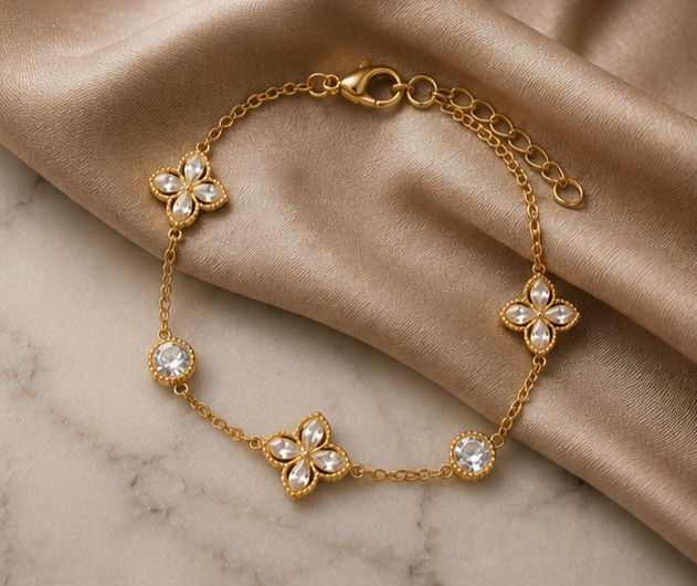 18K Gold Plated Crystal Clover Bracelet sat on cream satin