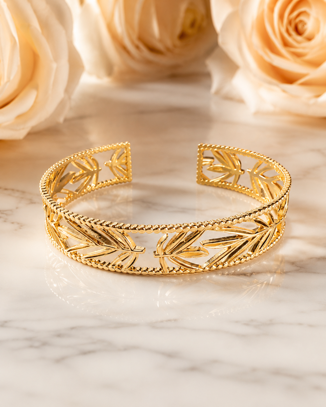 18K Gold Plated Leaf Bangle sat on white marble