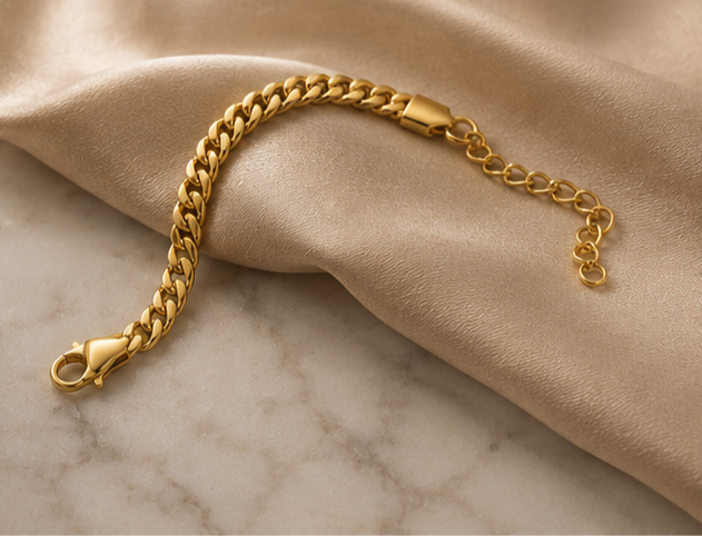 18K Gold Plated Cuban Link Bracelet sat on cream silk