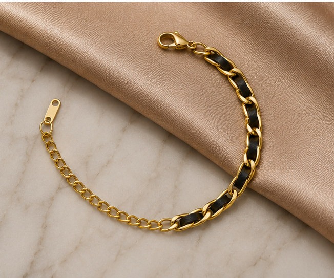 18K Gold Plated Black and Gold Bracelet sat on marble and satin