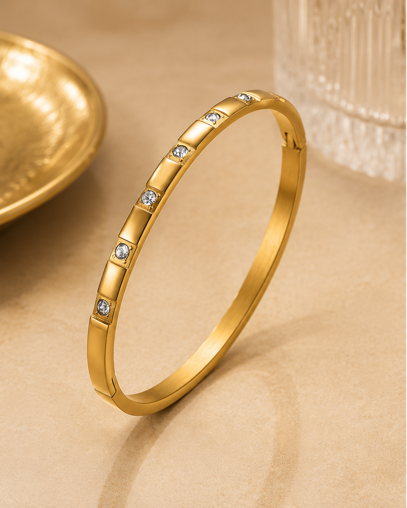 18K Gold Plated Crystal Oval Bangle standing on stone