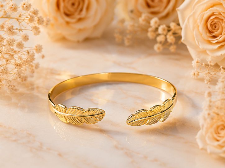 18K Gold Plated Feather Bangle sat on white marble