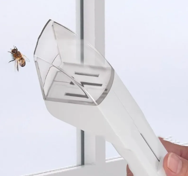 SafeCatch humane insect catcher tool gently holding a small bug