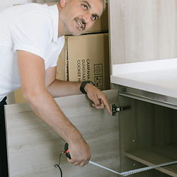 Man inspecting open cabinet