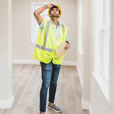 Man in hard hat inspecting ceiling