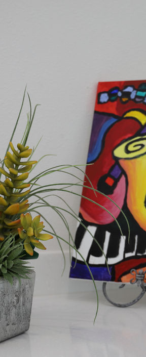 Colorful artwork and indoor plants creating a calming atmosphere at The Rowlett Dentist in Rowlett, TX