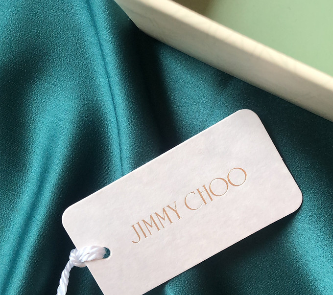 Jimmy Choo tag on a green satin fabric