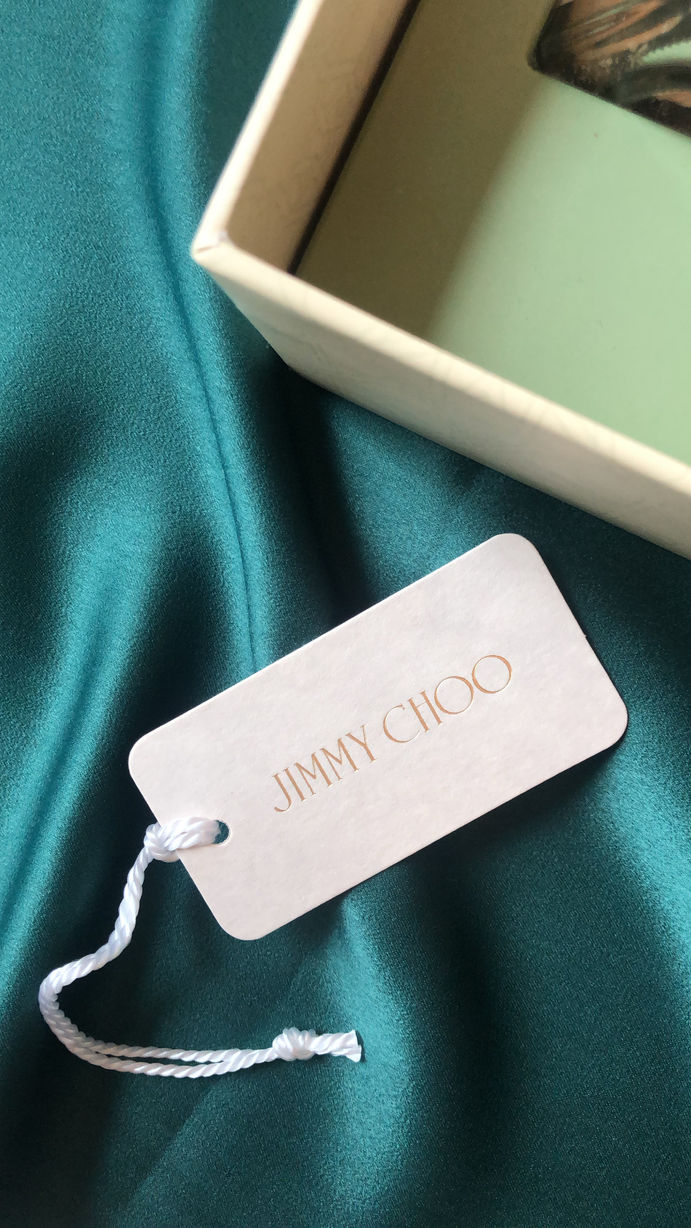 Jimmy Choo tag on emerald green silk fabric
