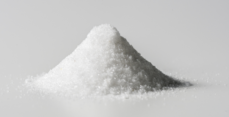 A pile of white sugar on a white background.