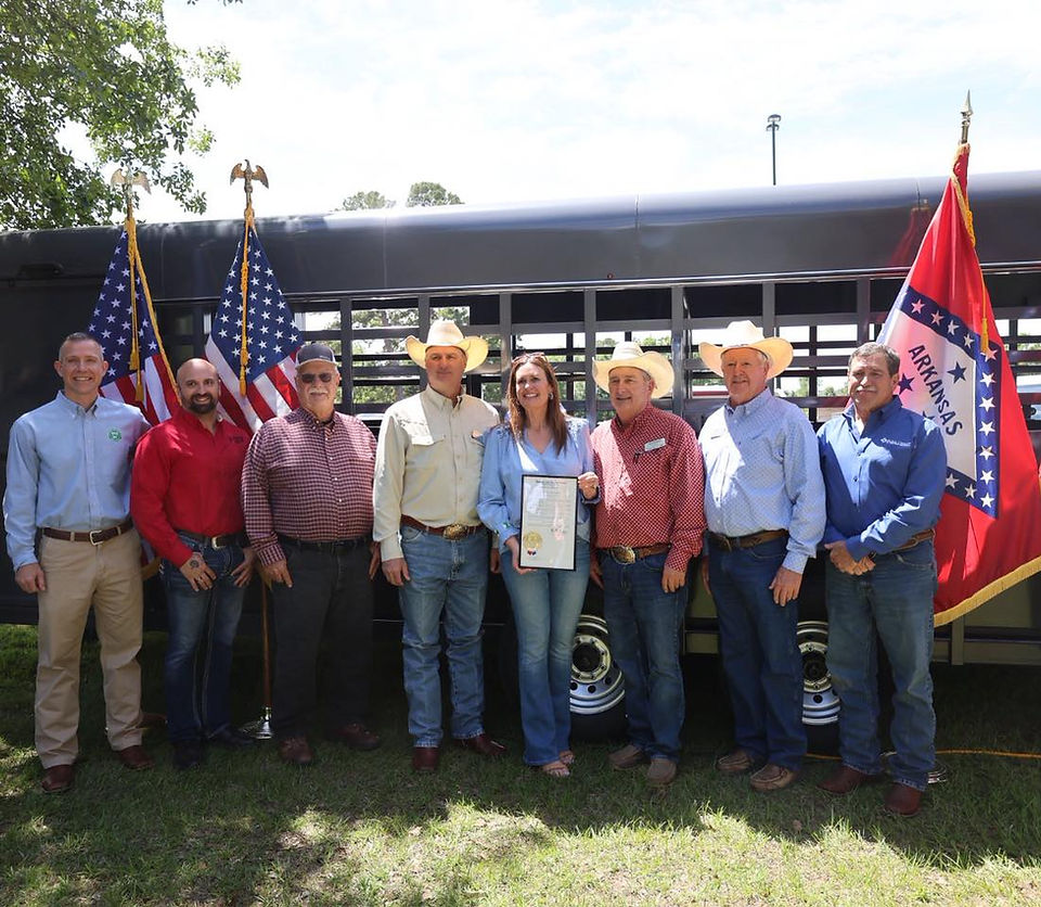 Cattle producers and Governor Sanders in front of a trailer
