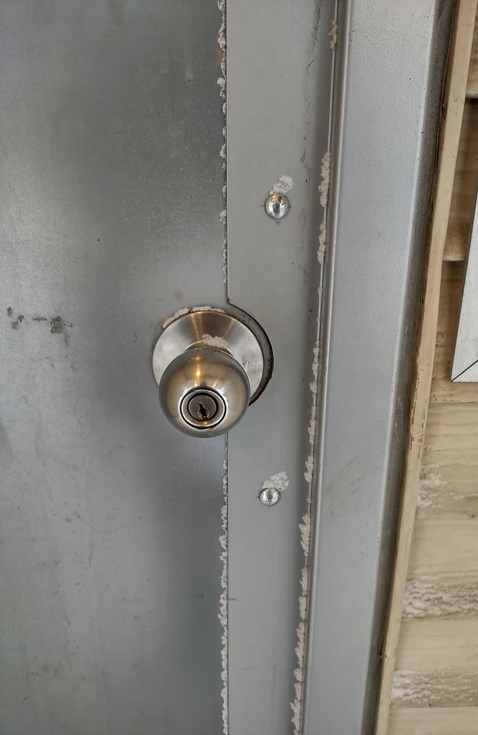 Damaged doorknob showing signs of forced entry by an intruder.