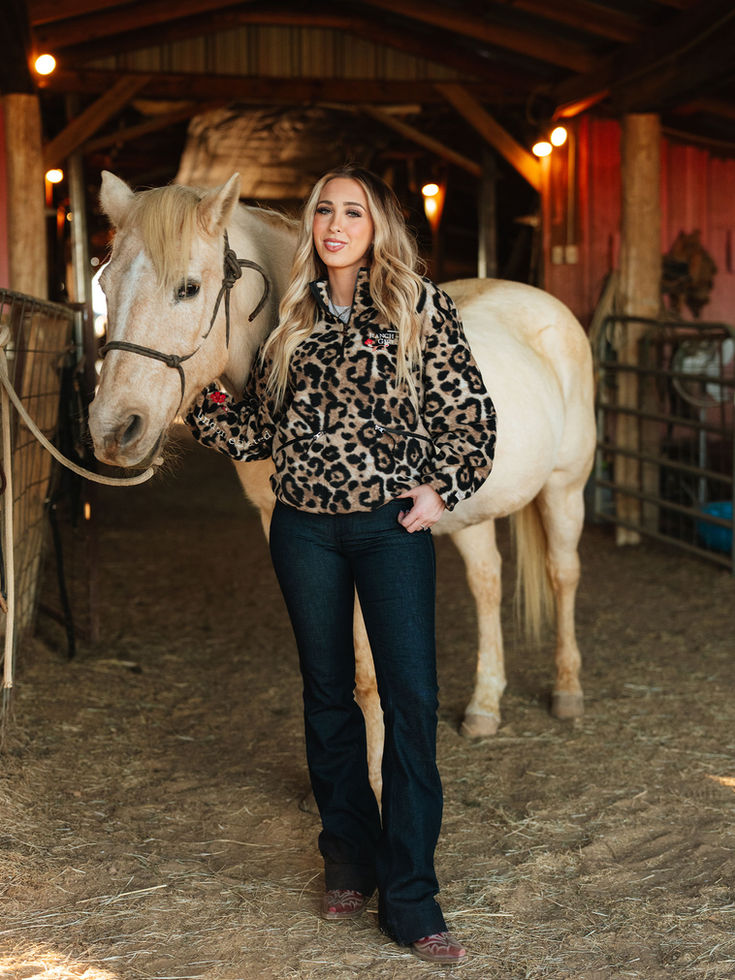 western fashion cowgirl is wearing a leopard, chita quarter zip and dark denim trouser Jeans