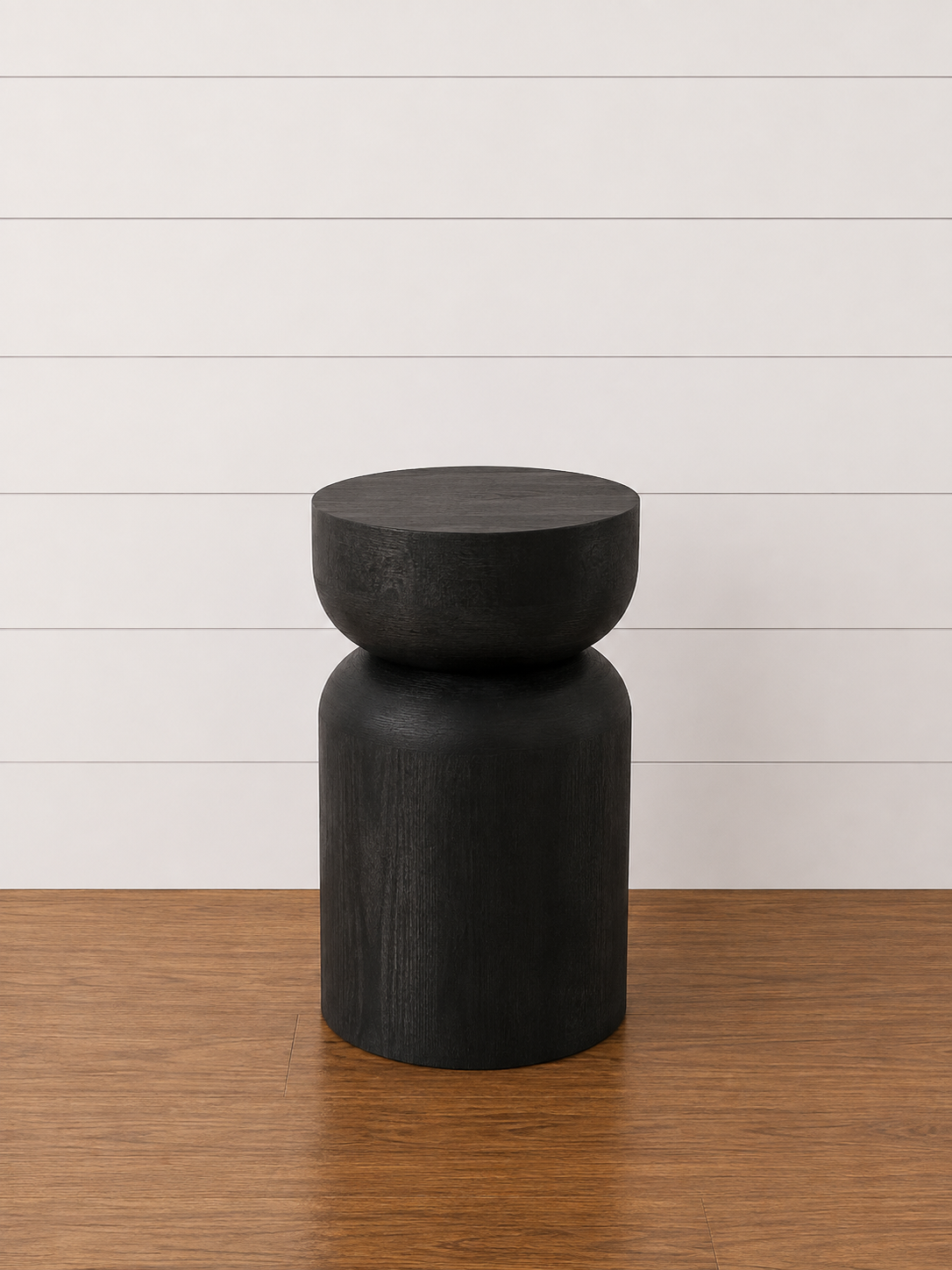 Black Callie end table with a sculptural hourglass design.