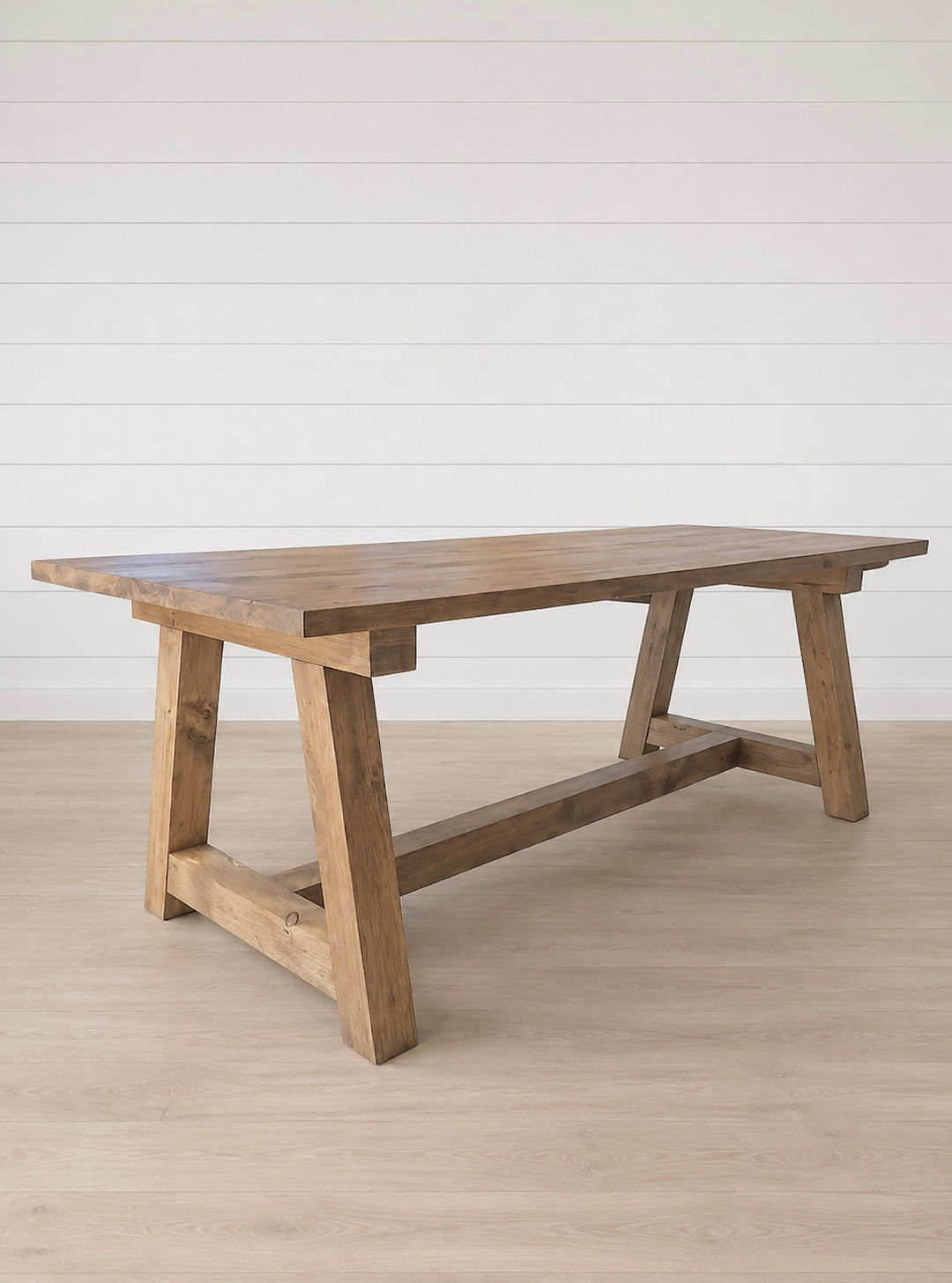 Arbor dining table in rustic wood with trestle base.