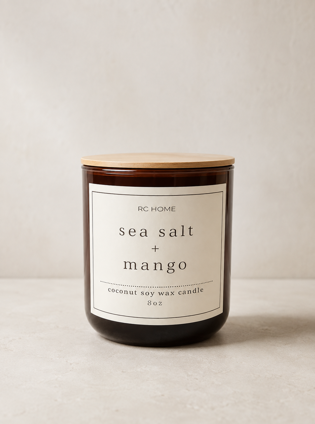 Sea Salt + Mango coconut soy candle in an amber glass jar.