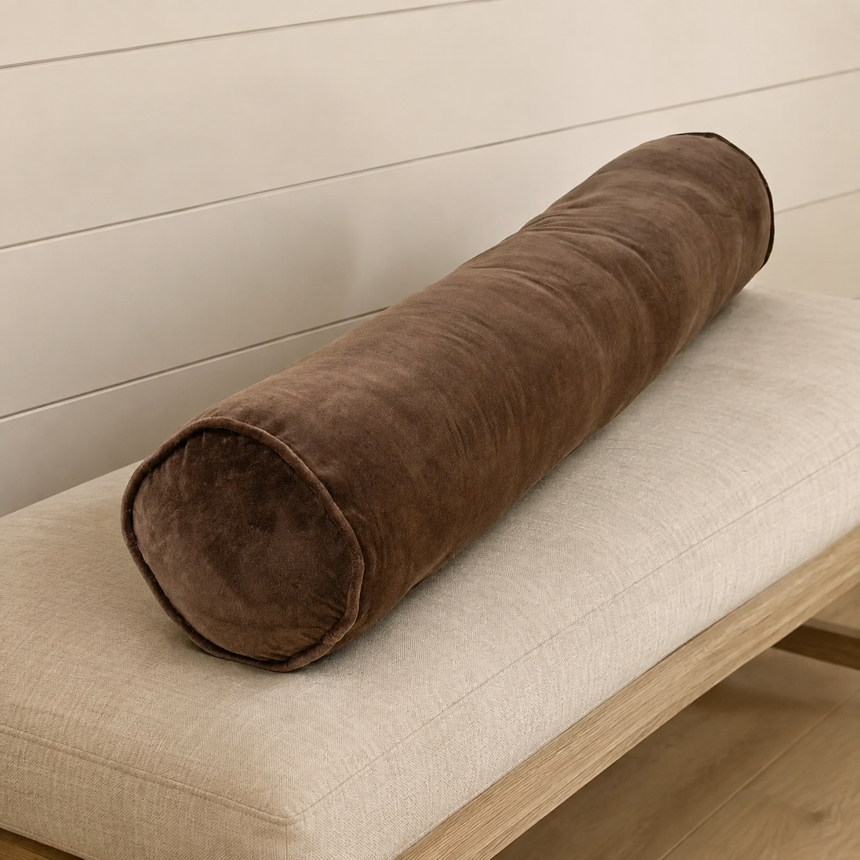 Vera Velvet Long Bolster in Clove on a neutral bench.