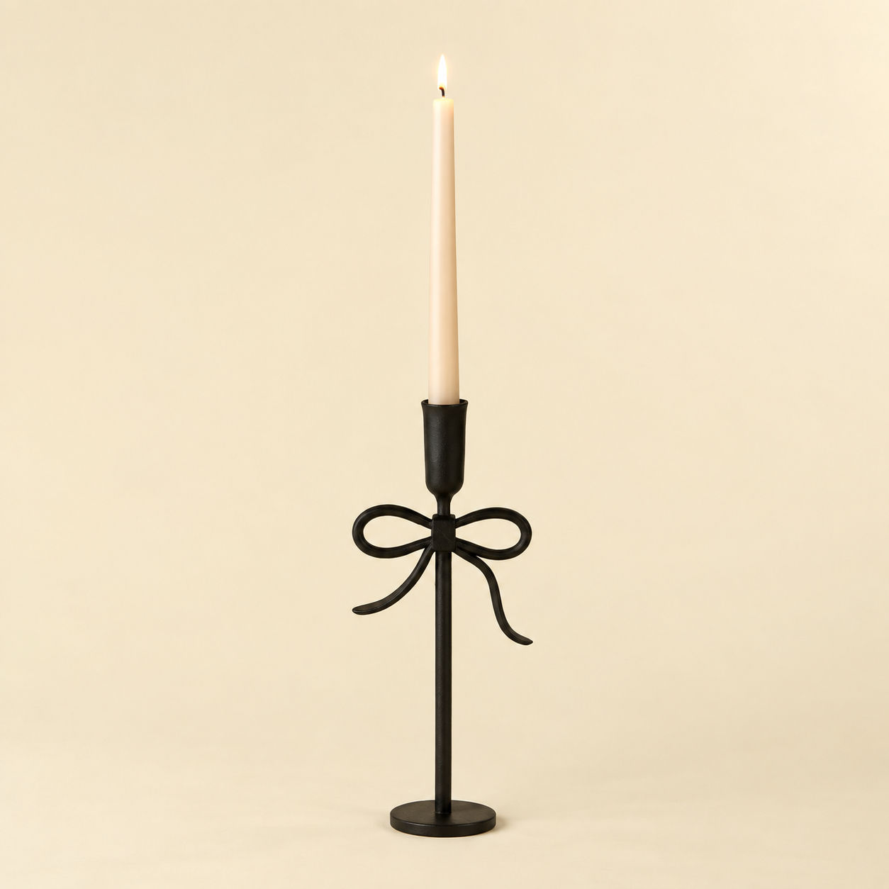 Black Bow Forged Candlestick with lit taper candle