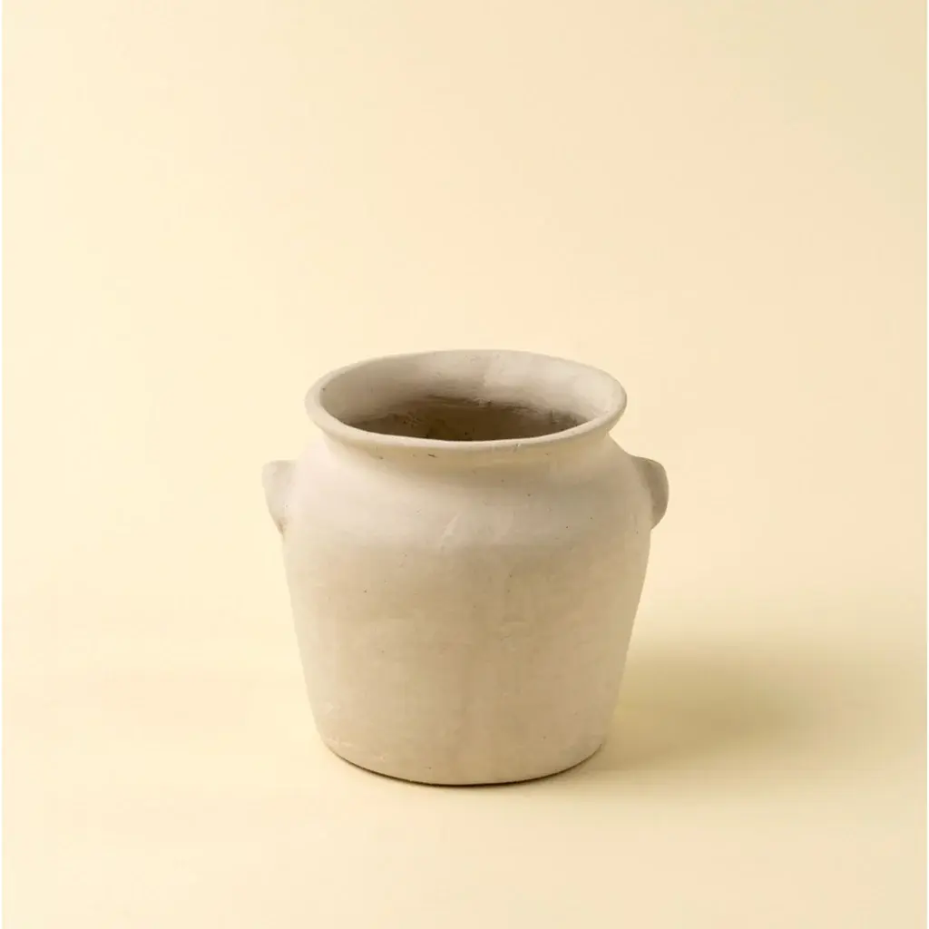 White pottery pot with handles, set against a cream background.
