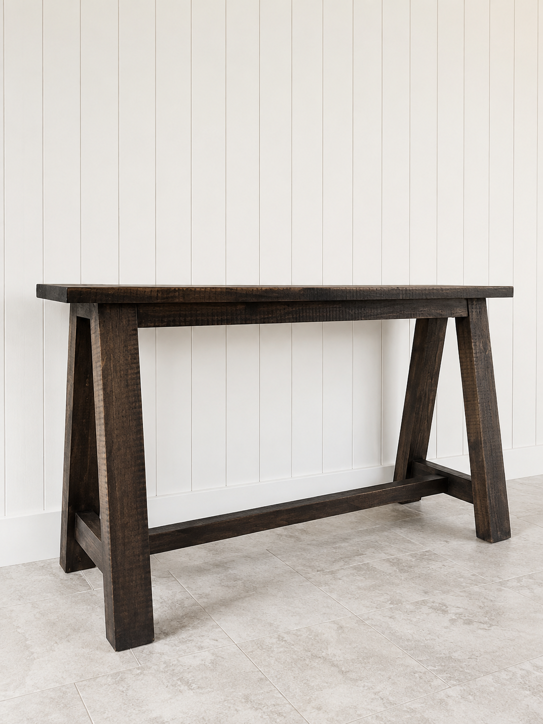 Rowe Console Table in dark wood with trestle legs.