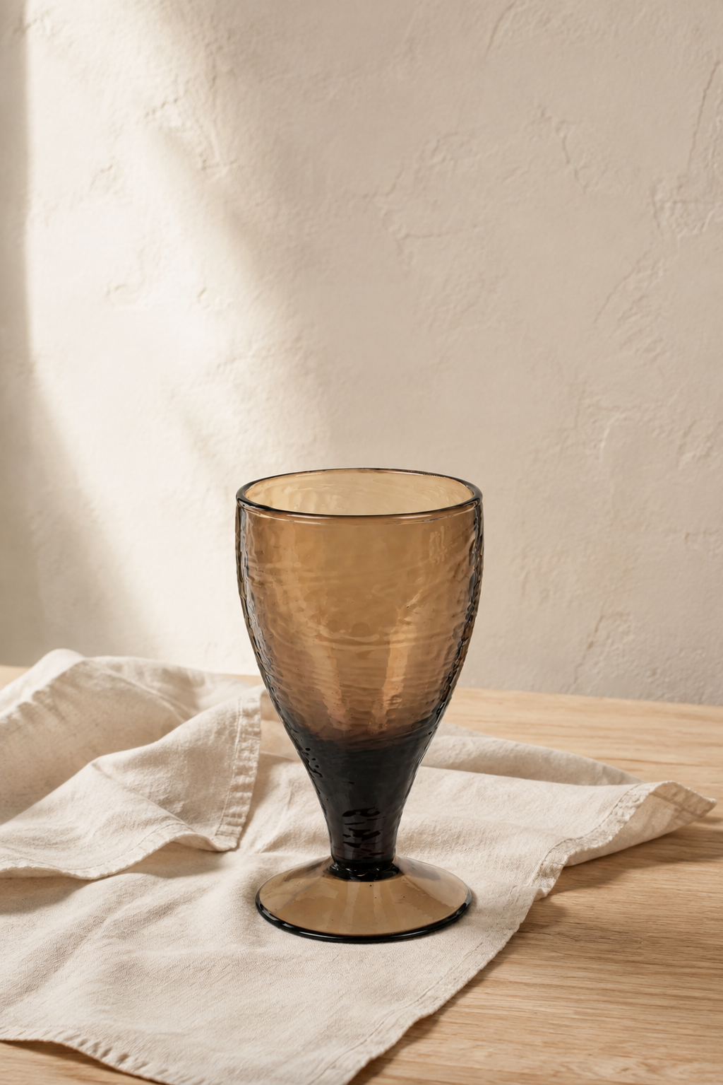 Amber Valdez Water glass on a neutral tablecloth.
