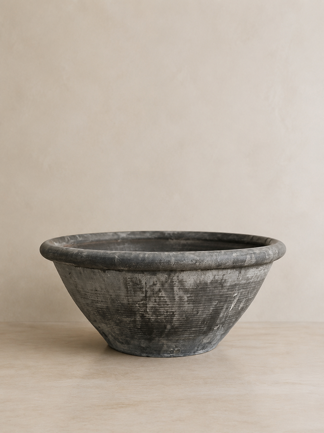 Large vintage basin in weathered grey stone.