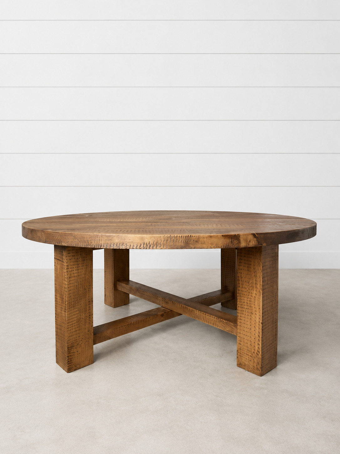 Round Marlowe wooden coffee table with X-base.