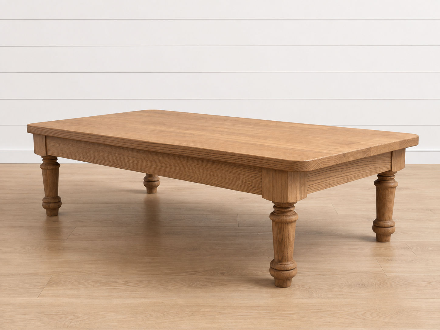 Arles Coffee Table with turned legs in a light wood finish.