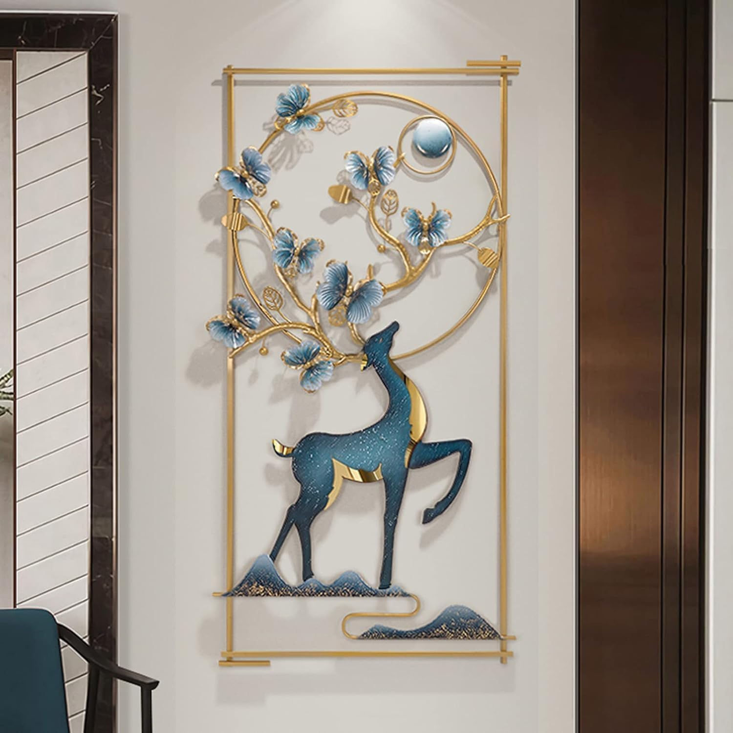 Deer art with gold frame, blue butterflies, and decorative background on a wall.