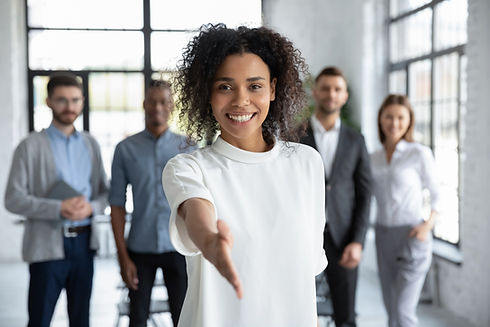Head shot portrait smiling African American businesswoman offering handshake, standing wit