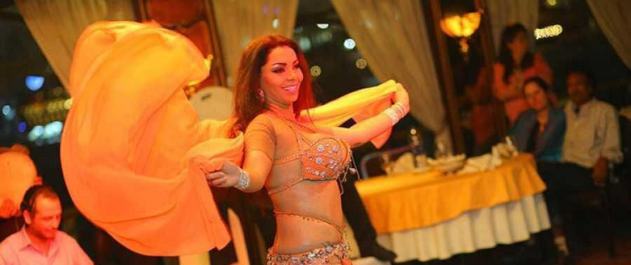 Tourists dining inside an elegant Nile dinner cruise restaurant in Cairo
