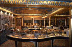 Tourists dining next to panoramic windows aboard the Nile Pharaohs dinner cruise in Cairo