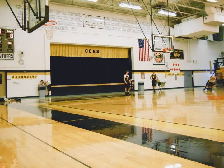 basketball team running sprints, some showing fatigue