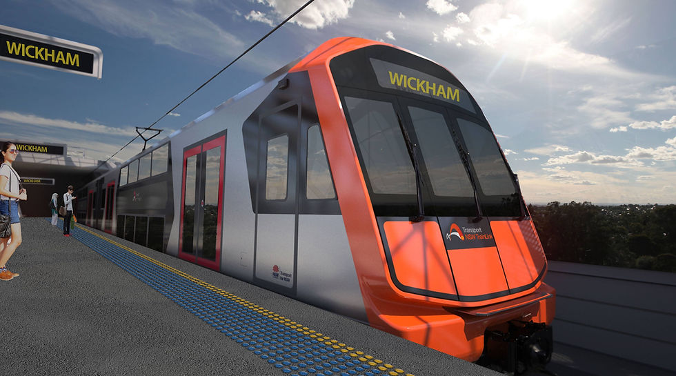 Futuristic orange-and-gray train at Wickham station with people on the platform under a bright sunny sky; TrainLink logo visible.